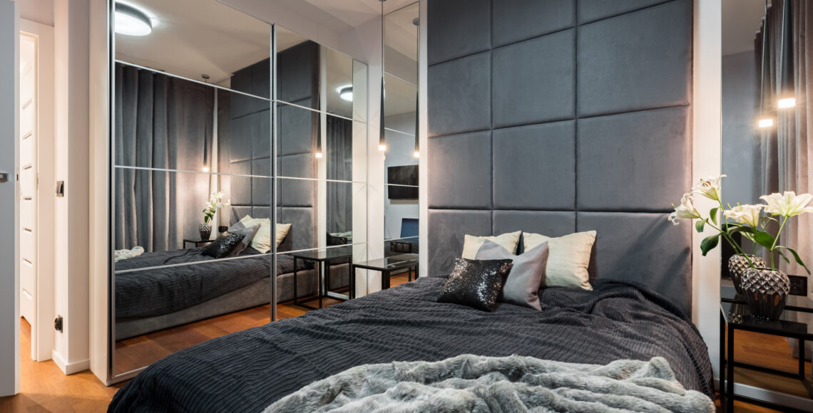 Sophisticated bedroom with mirror sliding door fitted wardrobe